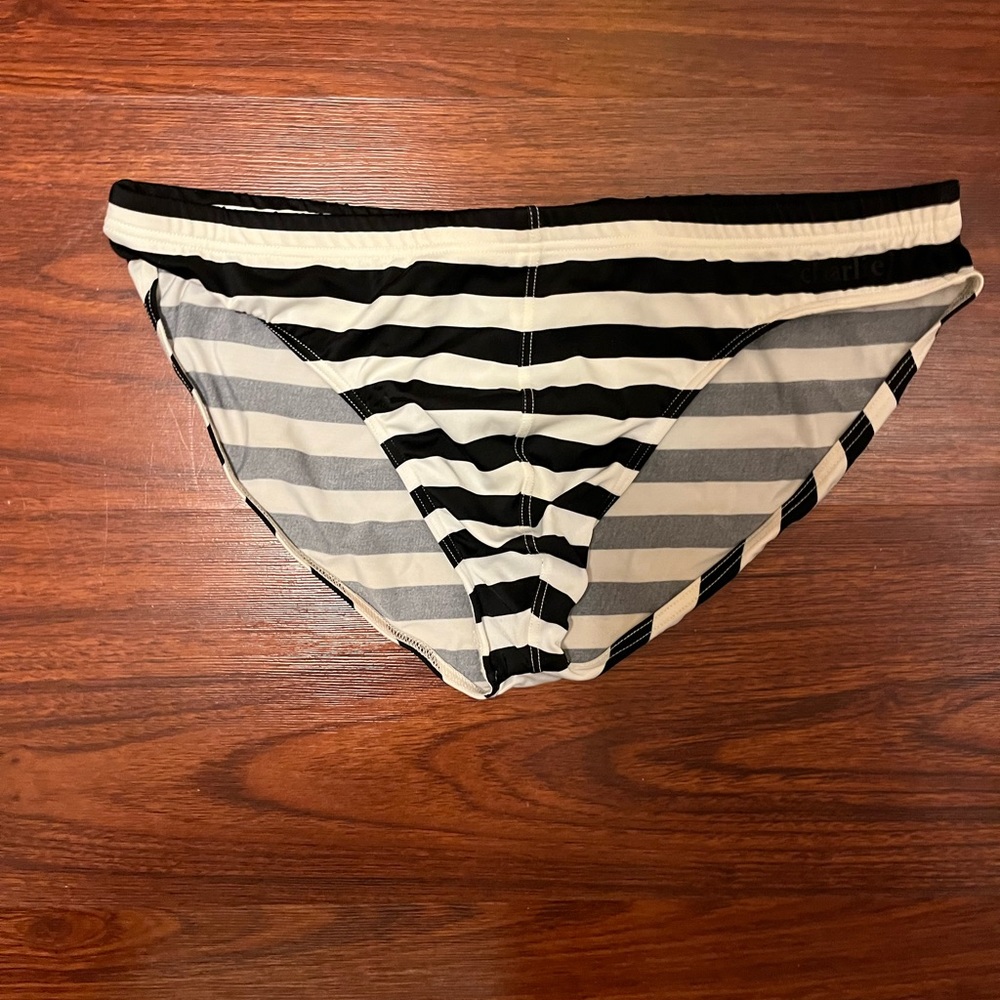 Charlie by Matthew Zink black/white striped in lifeguard speedo